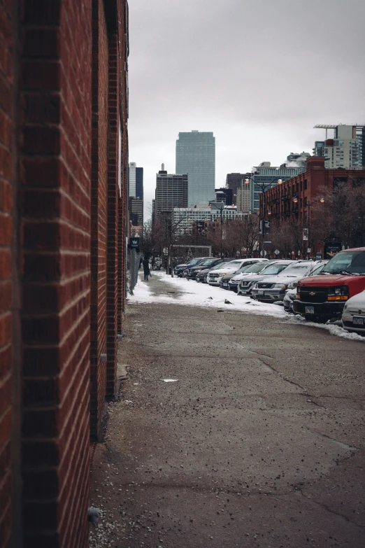 a street filled with lots of cars sitting next to tall buildings