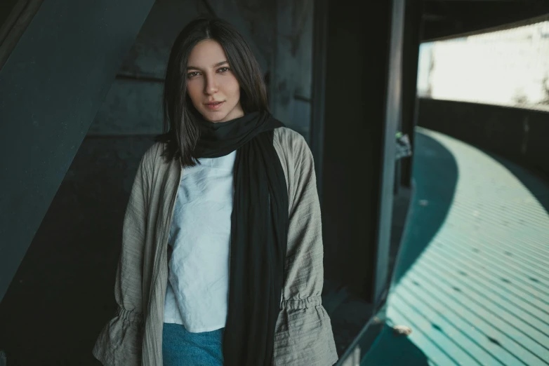 the woman is standing near the ramp wearing a scarf