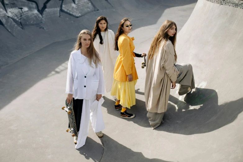 five women standing by a ramp and one in white coat