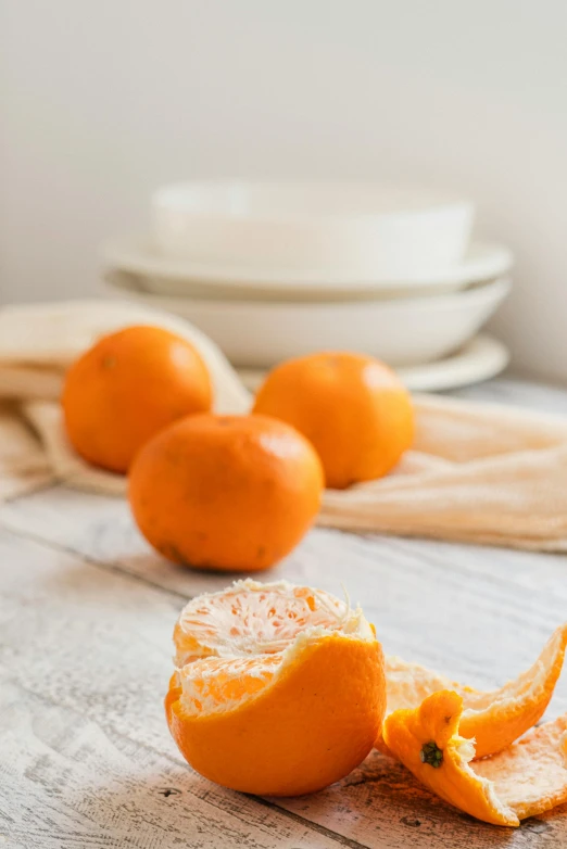 two orange peels with one cut open on top of a table