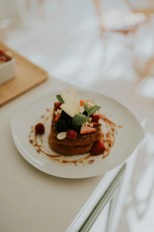 a piece of fruit - style crepe topped with almonds and strawberries