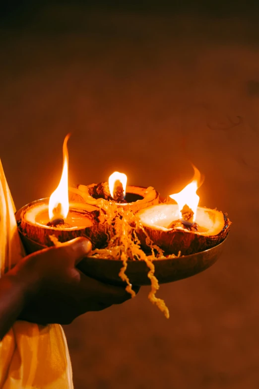 two people hold a plate with flames in each one