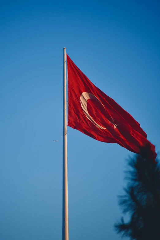 a large red flag with two white circular dots on it