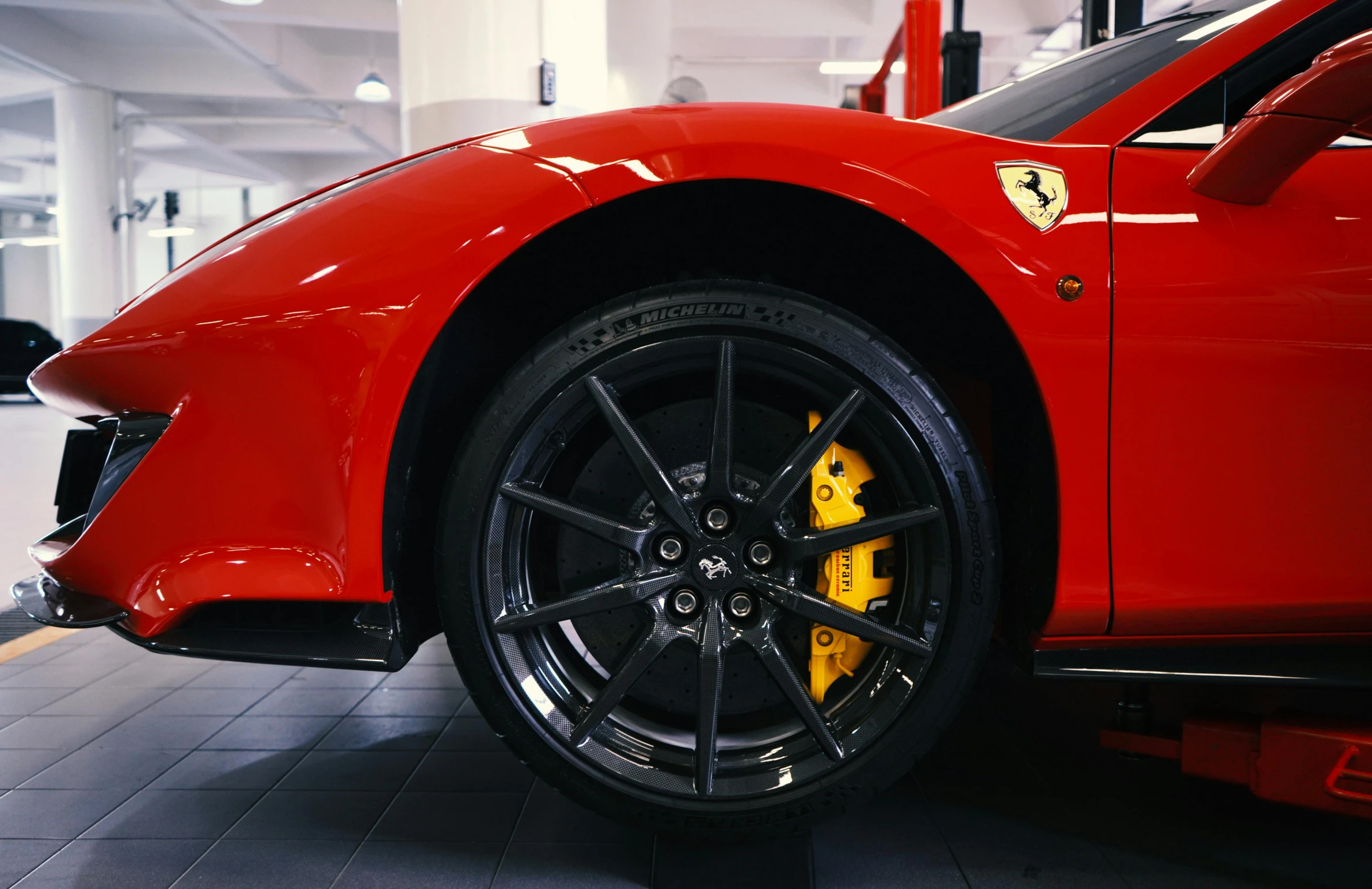 the front wheels of a red sports car