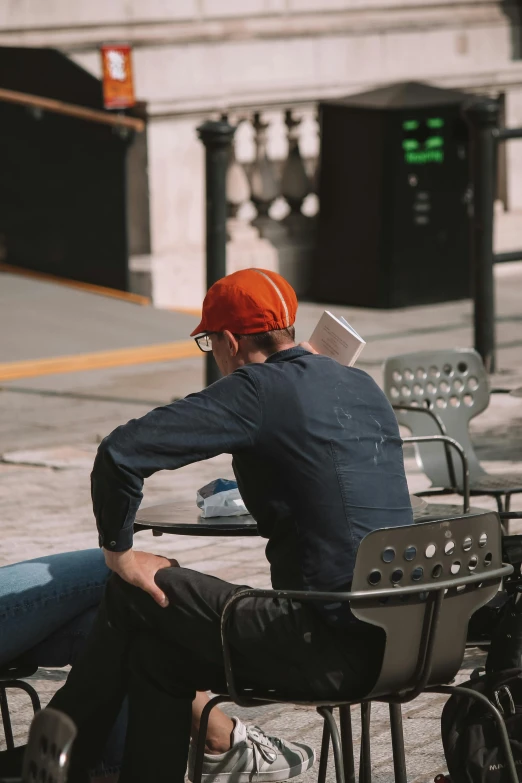 a man sits in a chair and reads