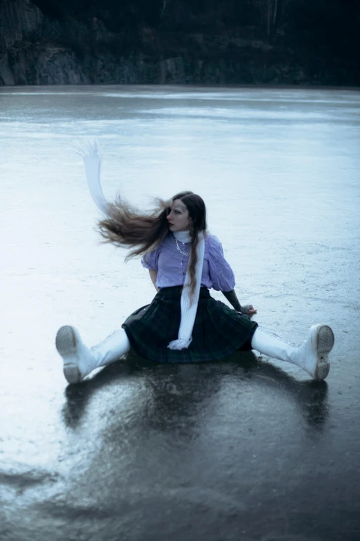 woman sitting on a rock in the water