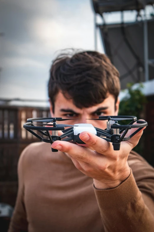 a man is holding up his flying device