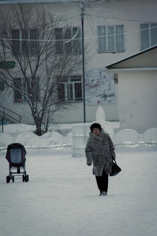 a woman in winter gear walks through the snow