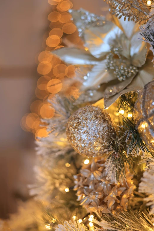 silver ornaments on the side of a christmas tree