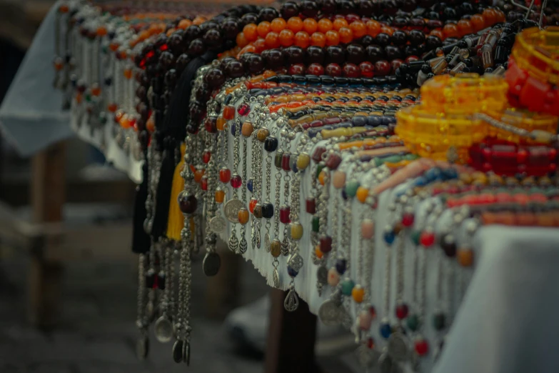 there are many different colored beads on display
