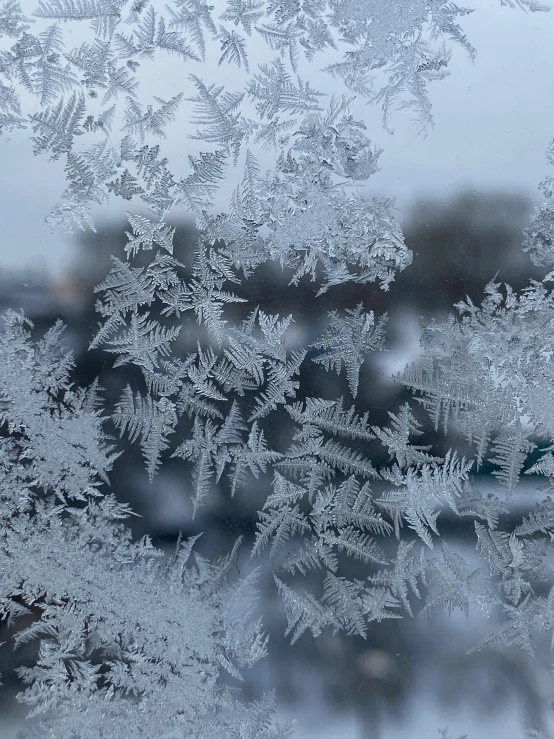 ice covered window glass with water on the window