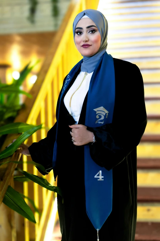 a woman is standing in front of some stairs