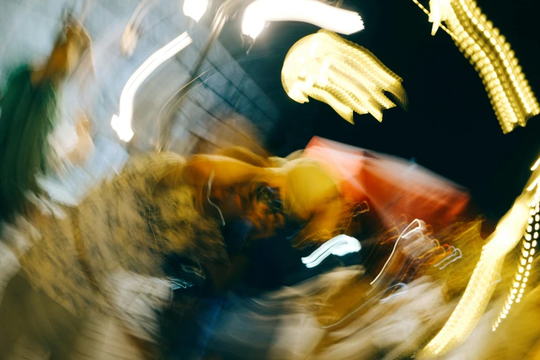 blurry pograph of colorful fair rides at night