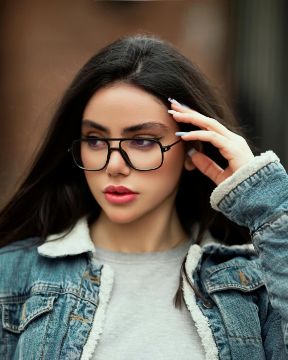 a woman with glasses on is covering her face