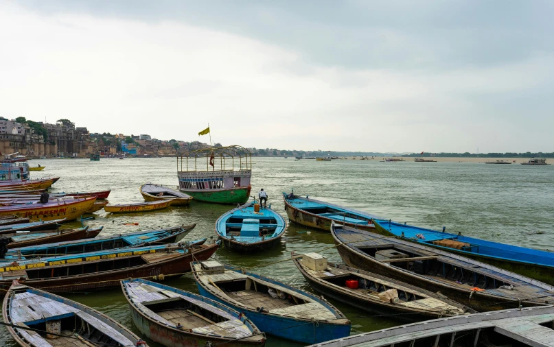 an old pograph of boats docked on the shore