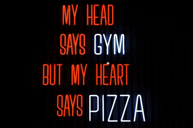there is a sign with the words my head says gym but my heart says pizza