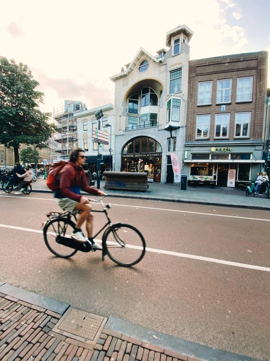 man on bike looking over the top of a pole