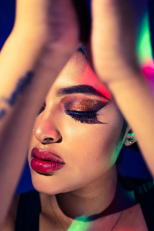 a beautiful woman with colorful makeup posing