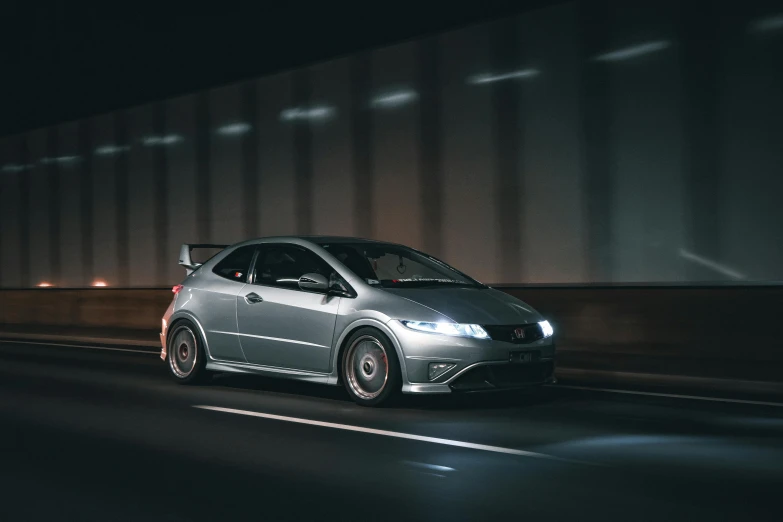 a car driving down the highway at night