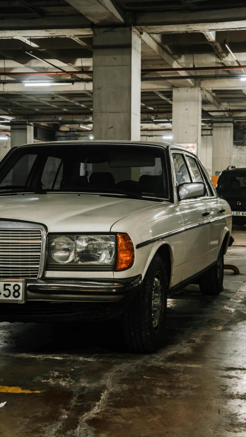 an old car parked in the parking garage