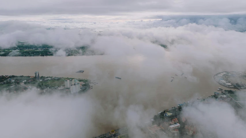 a picture taken from a plane with some clouds over a city