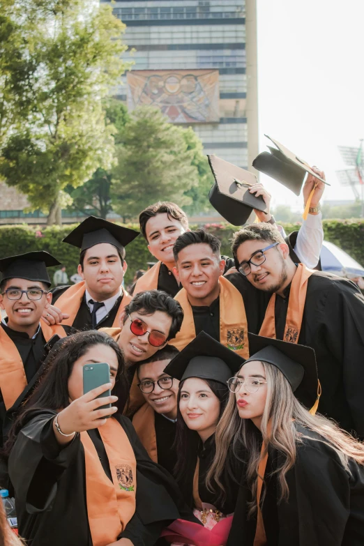 there is a group of people in graduation clothes posing