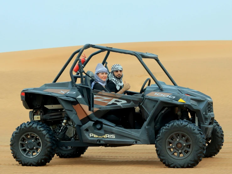 a man drives an off - road utv through the desert