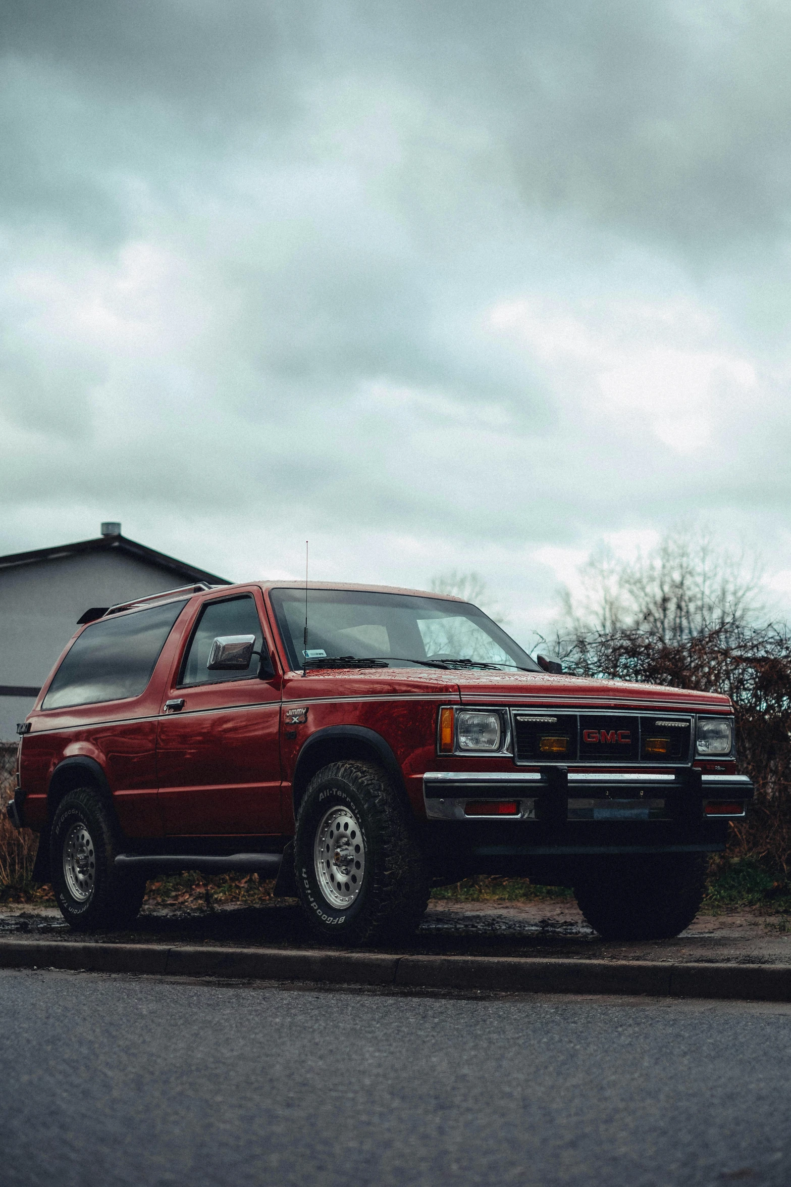 a red pick up truck parked in front of a building