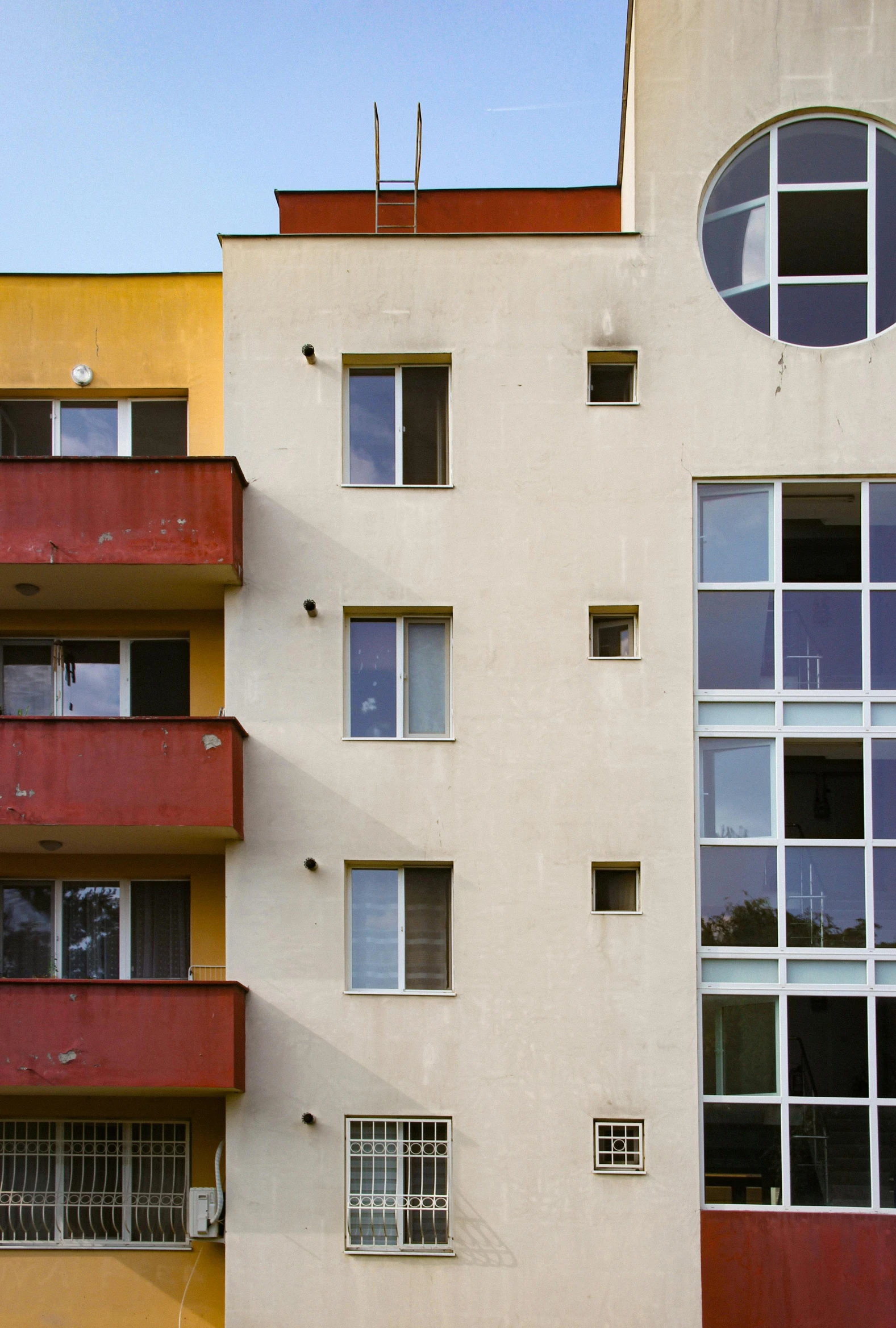 the windows and balconies of a multi - story apartment building