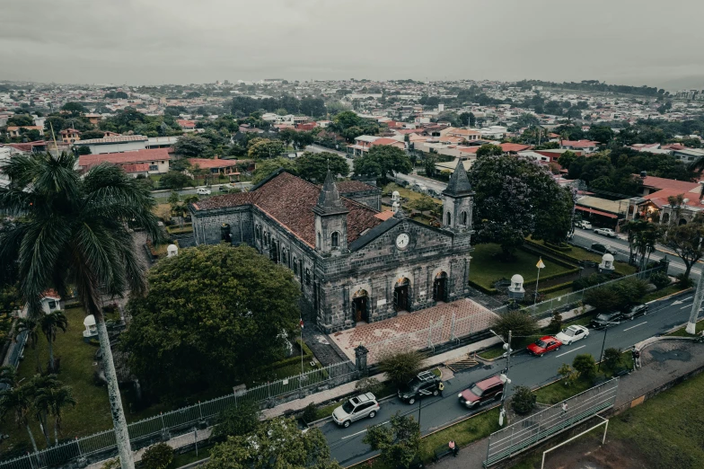 a large stone church on a hill near a city