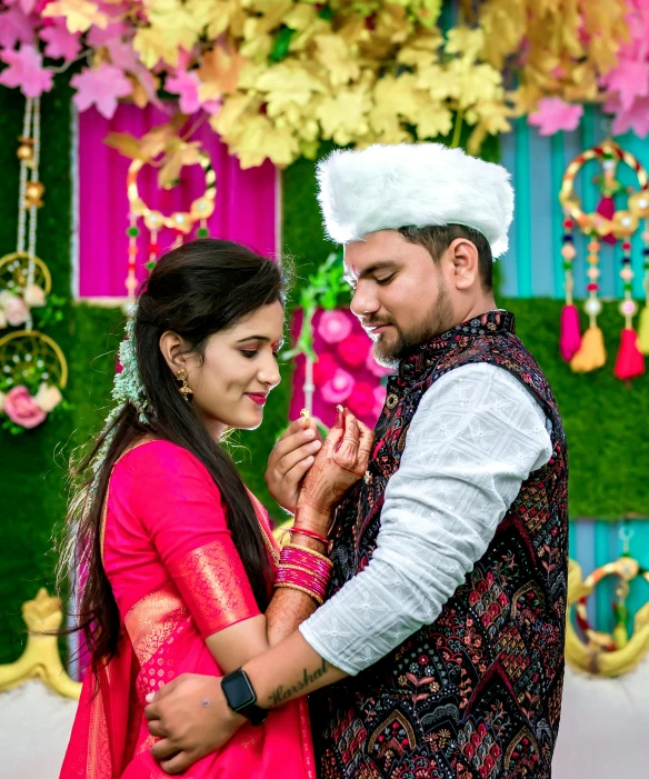 a newly married couple in front of colorful backdrop
