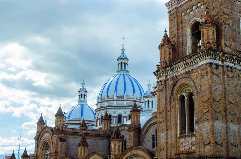 a view of a large church, dome, and doorways