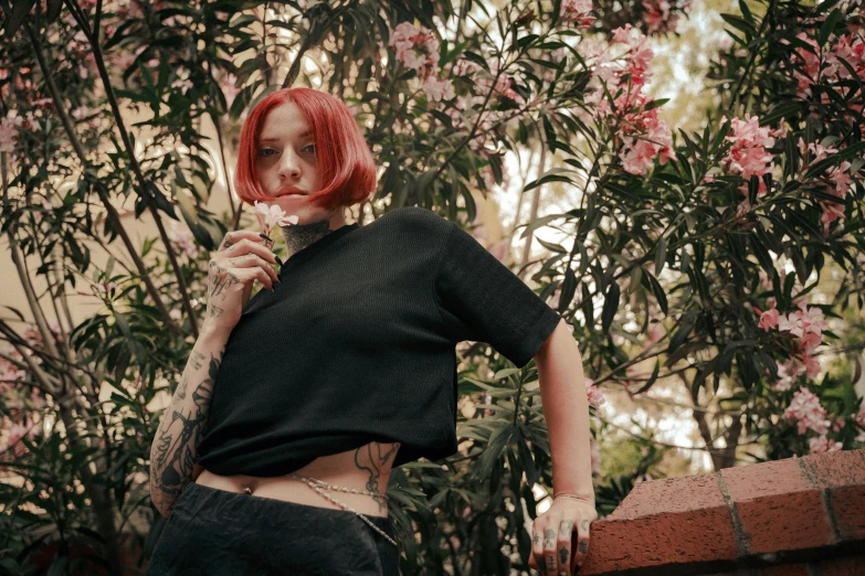 the woman is posing on a flowered building