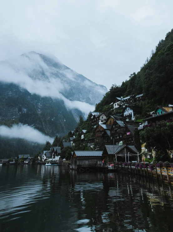 a village on the side of a mountain next to the ocean