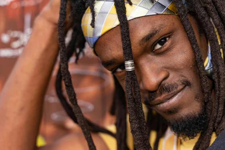 a man with dreadlocks looking at the camera