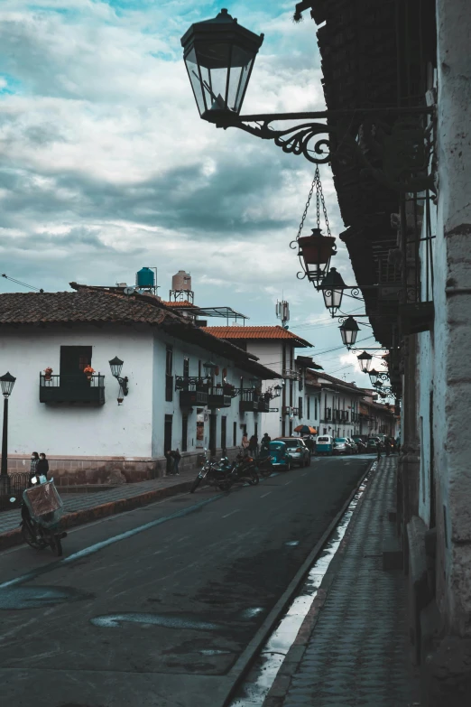 a street in an old city with people on bikes