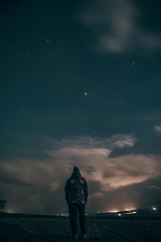 a person standing on a grass field at night