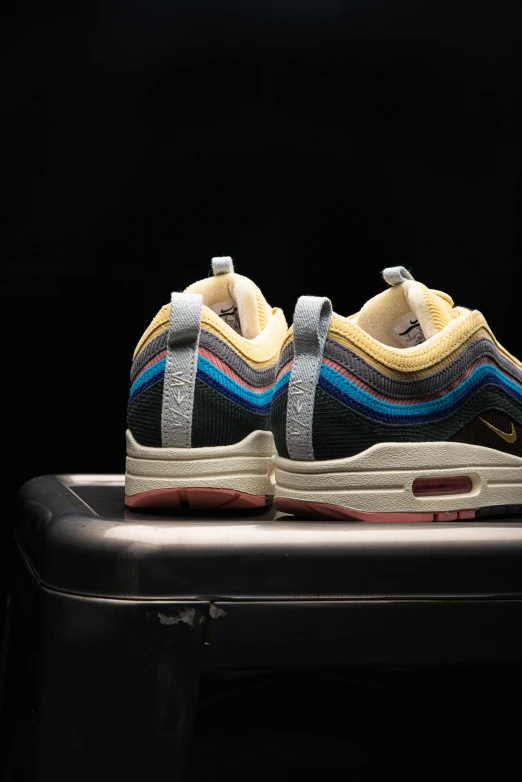 a nike sneakers with an off white stripe design and blue and yellow on the upper