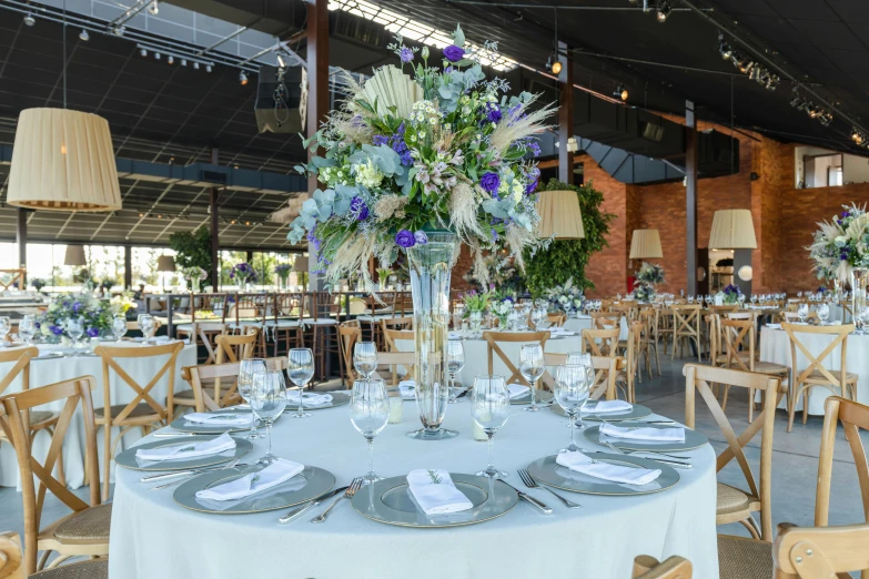 a dining room is set up with white and purple tables