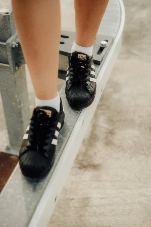 a close up of two pairs of shoes sitting on a skateboard