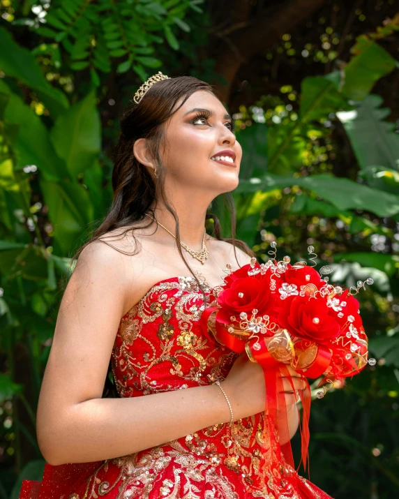 a woman in a red and gold dress holding flowers