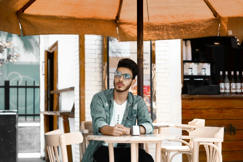 a man sitting in an outside restaurant setting