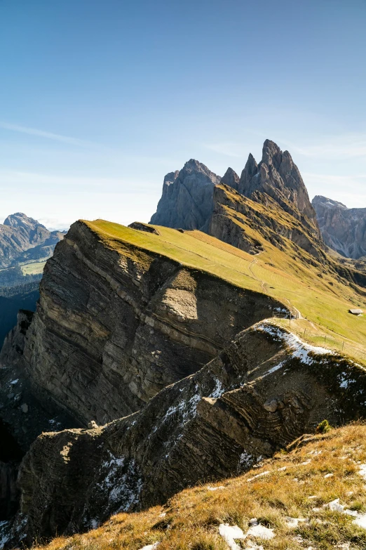 an empty field with horses on the side of a mountain range