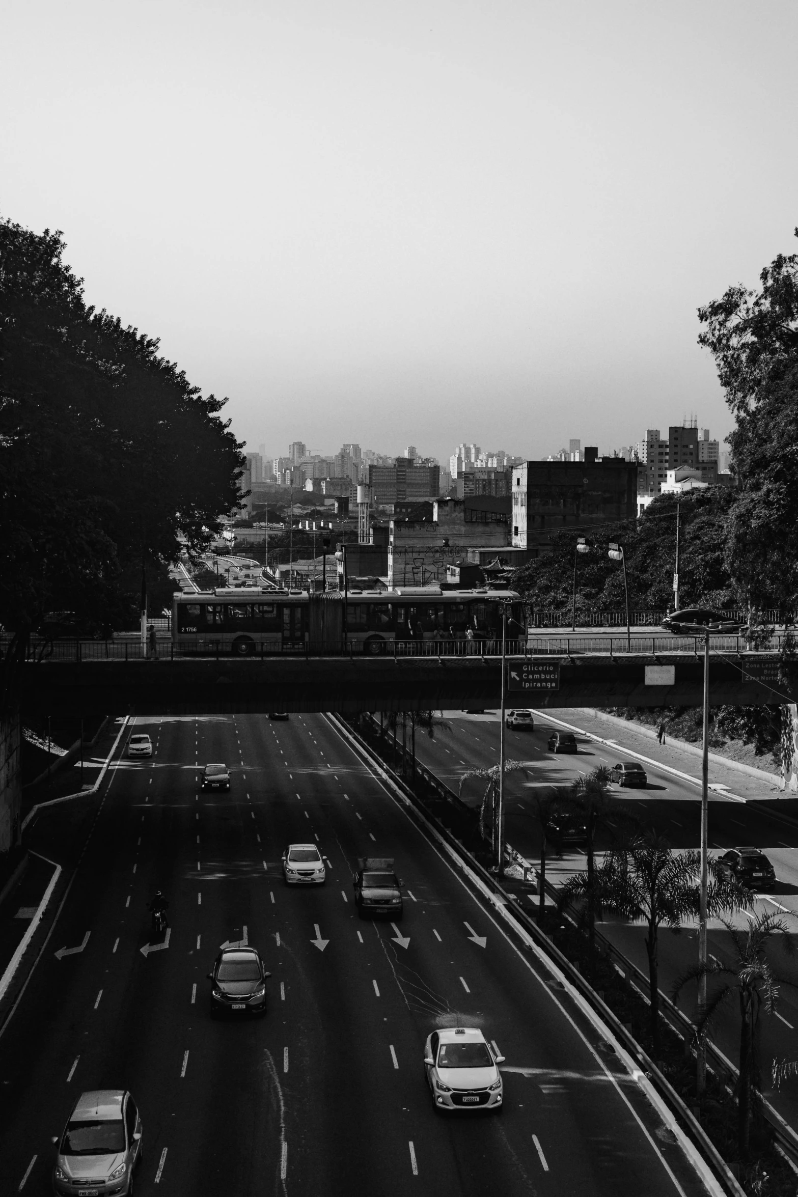 a black and white picture of a street in the city