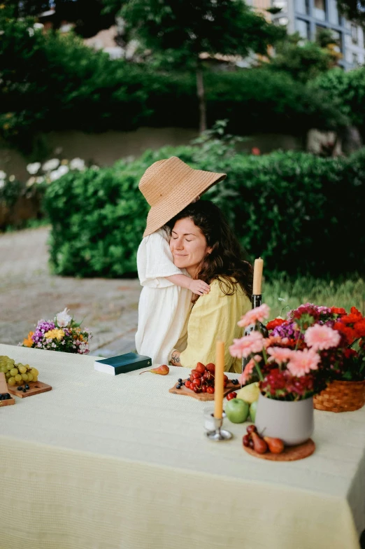 two women are sitting at a table together