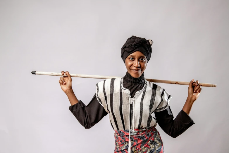 an african american woman holding a large stick