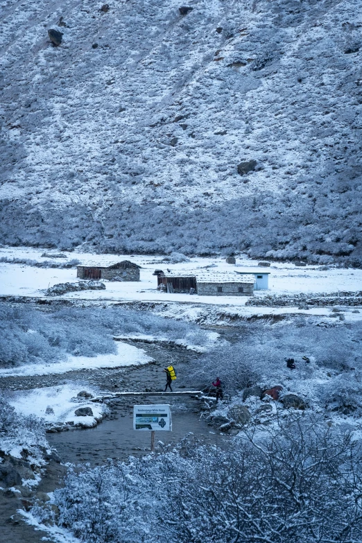 a person walking across a large snow covered field