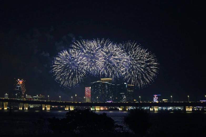 a large fireworks display over a city skyline