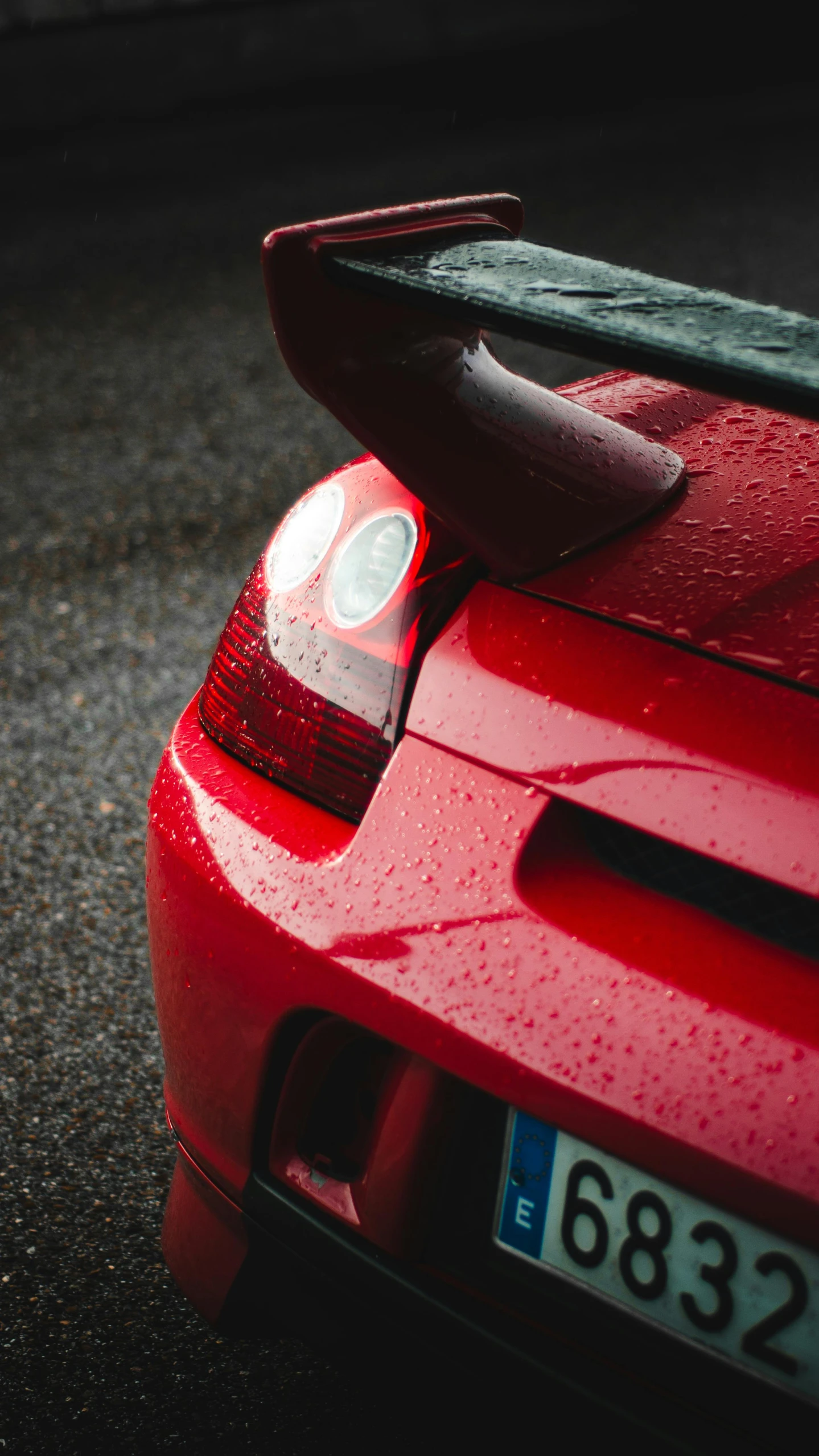 a red sports car parked on the side of the road