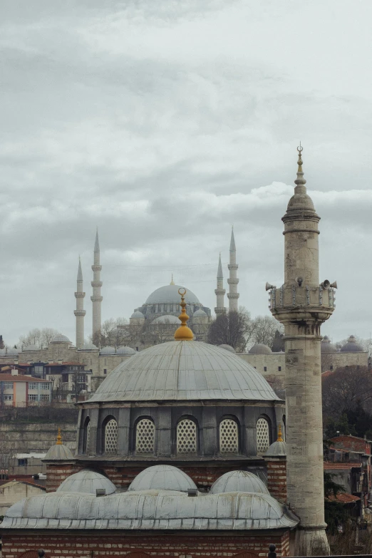 the buildings and spires of this islamic mosque are covered in snow